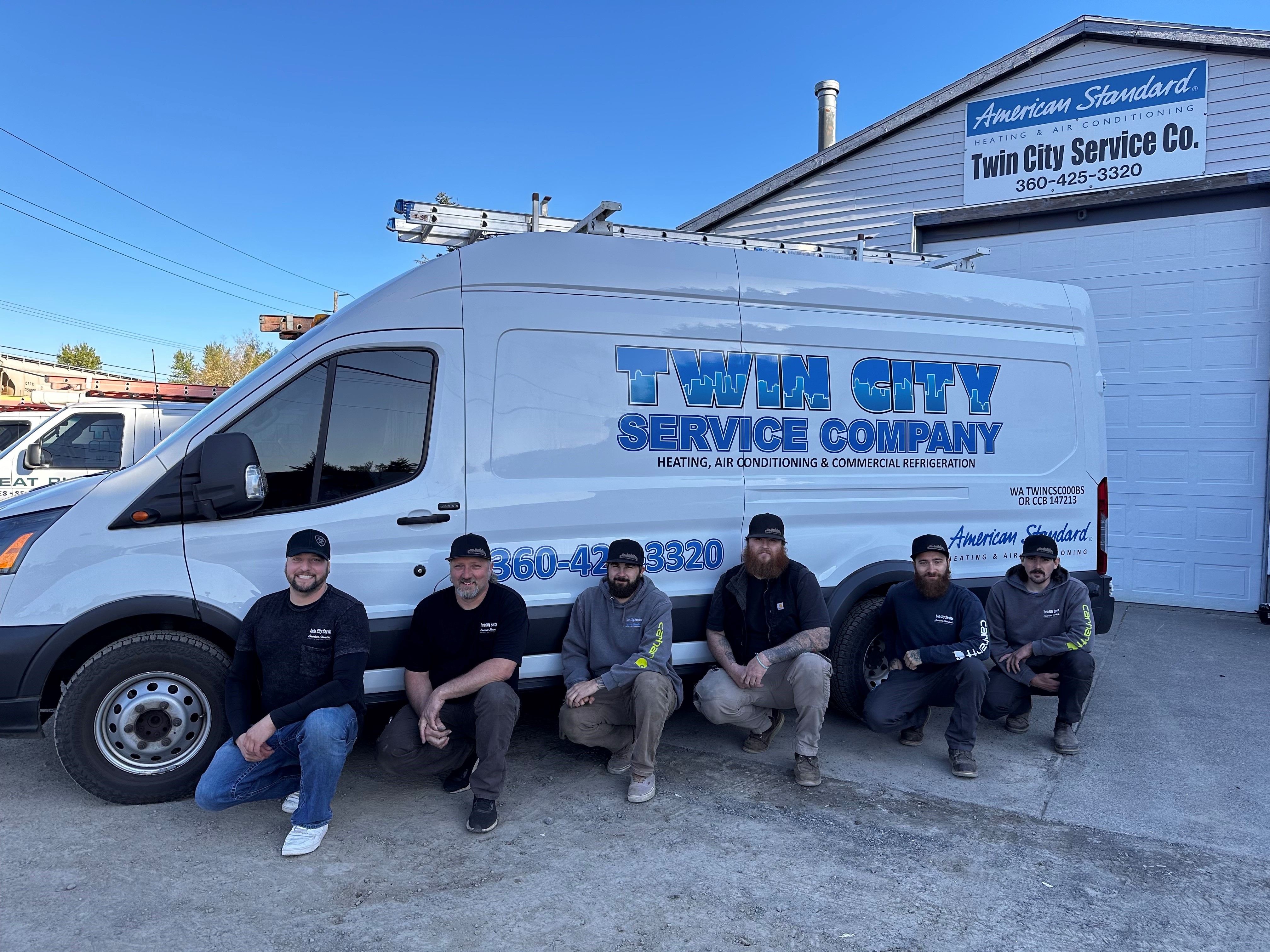 The Twin City Service Co. team in front of a company service van at their Kelso, WA shop